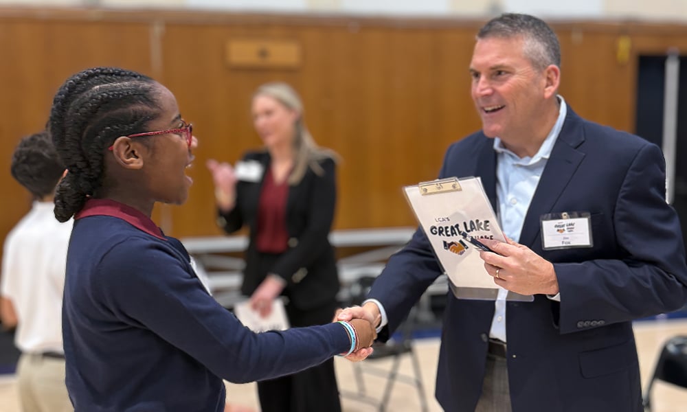 A student shaking hands with a donor