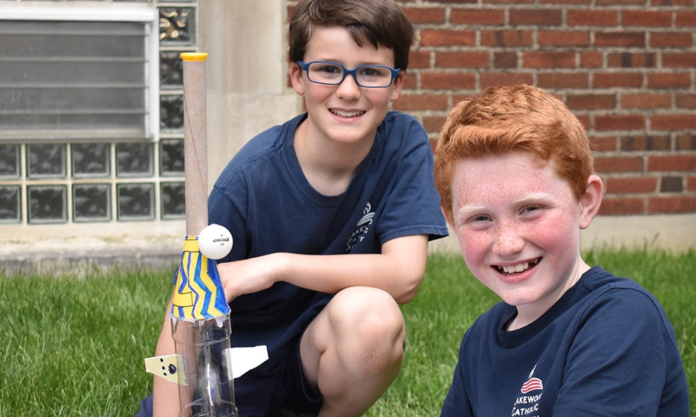 Two male students working outside