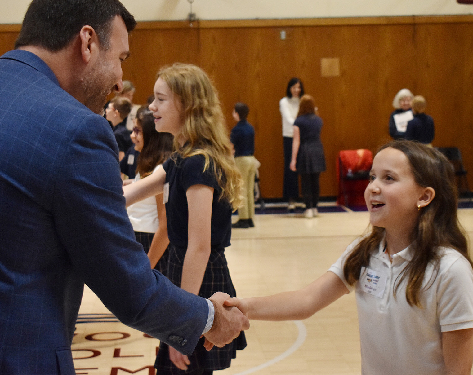 Student shaking hands with an adult